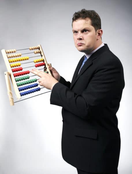 Confused accountant calculating with a multicolor abacus. Studio shot.